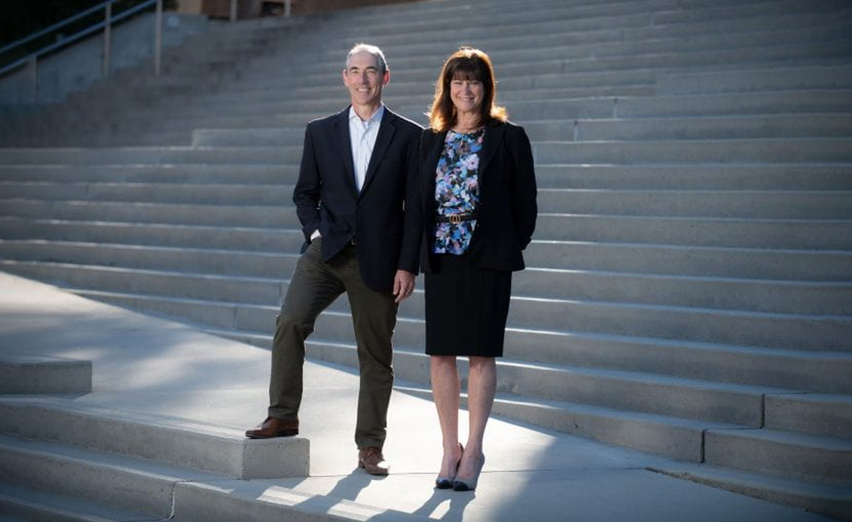 IPH co-directors Tom Andriola and Leslie Thompson in front of stairs